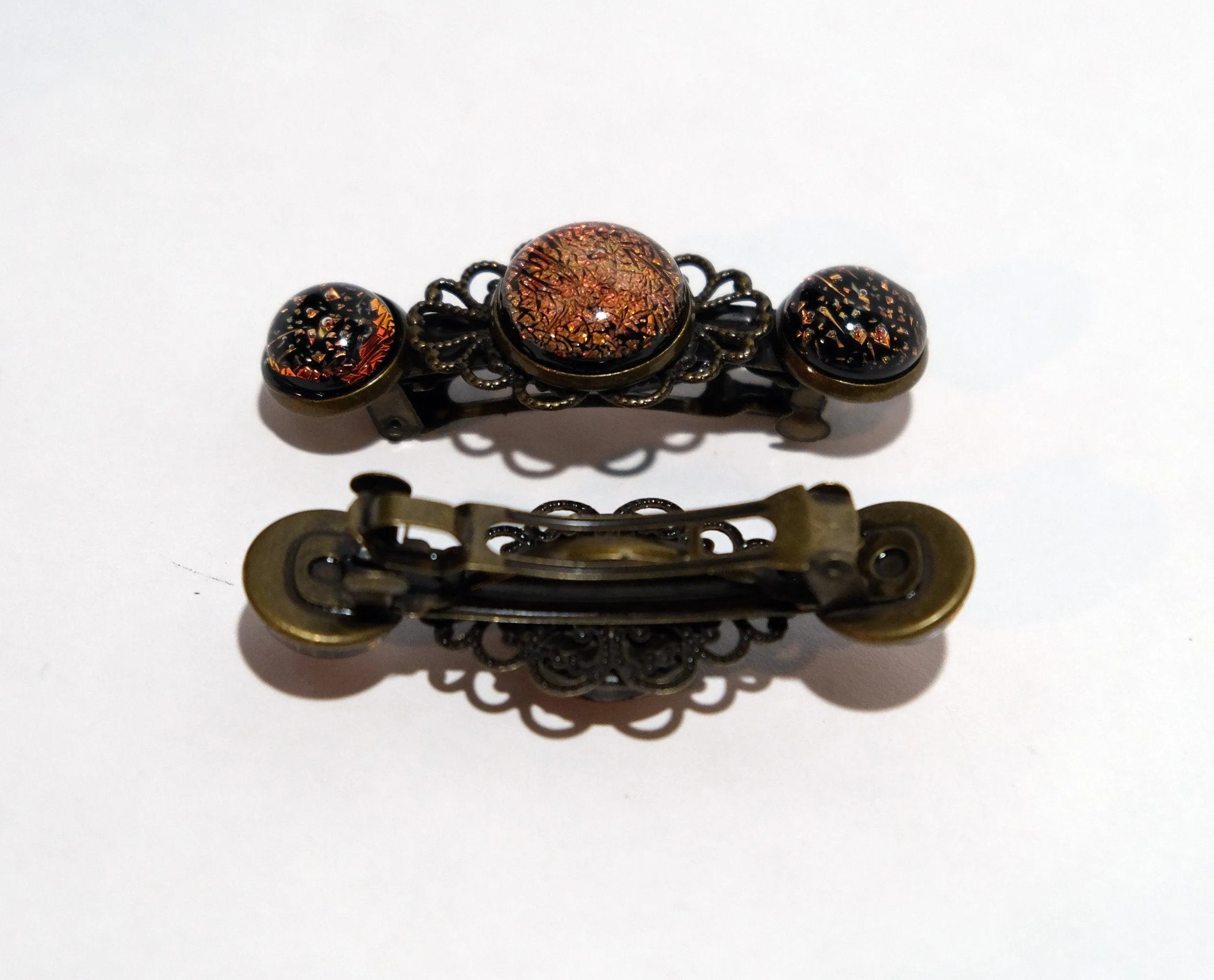 Barrette pair, bronze flowers with orange dichroic fused glass cabochons, french clip, 2 1/4 inches