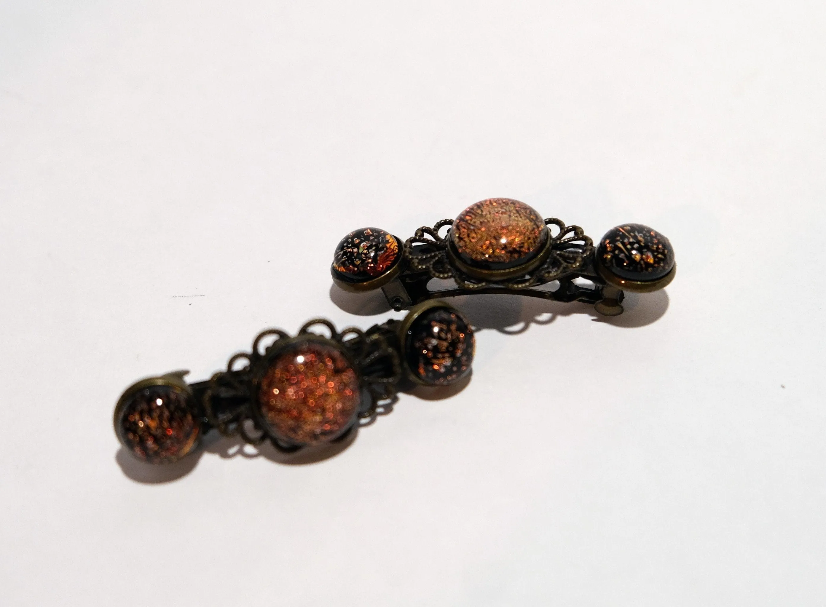 Barrette pair, bronze flowers with orange dichroic fused glass cabochons, french clip, 2 1/4 inches