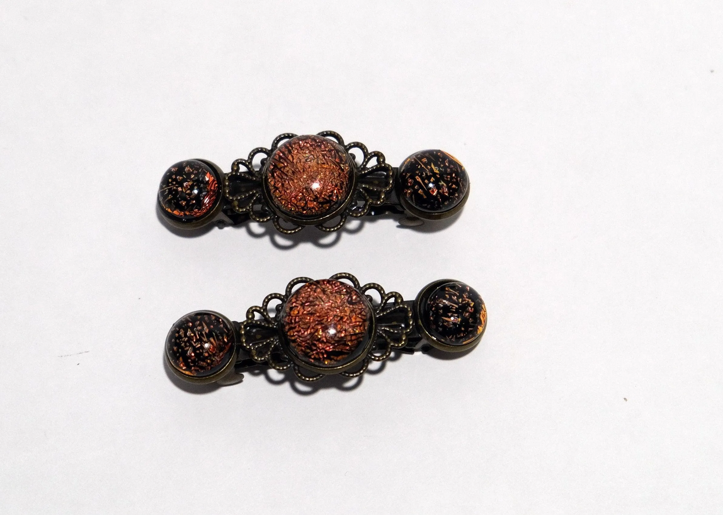 Barrette pair, bronze flowers with orange dichroic fused glass cabochons, french clip, 2 1/4 inches